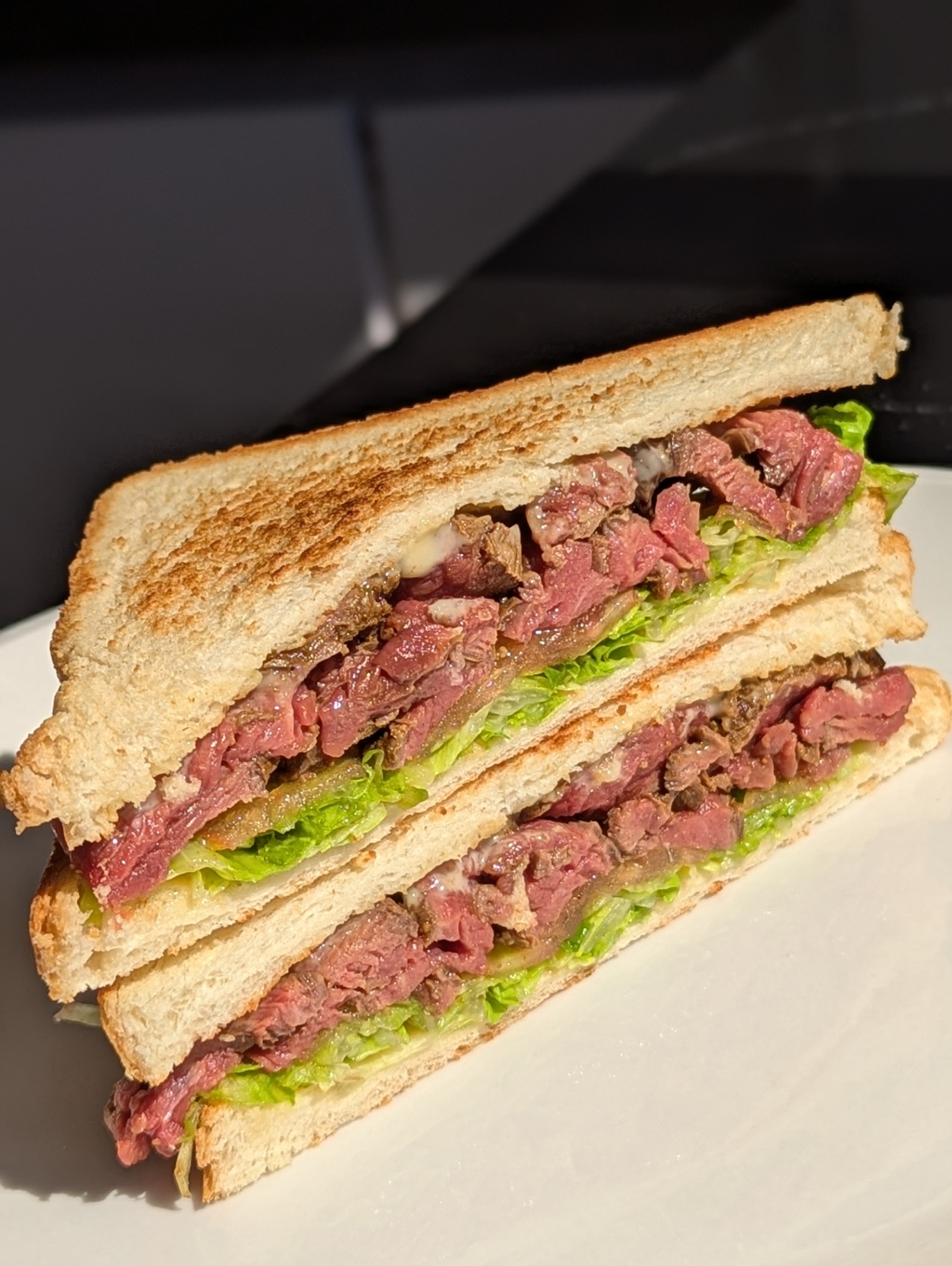 Toasted steak sandwich with rare beef and crisp lettuce