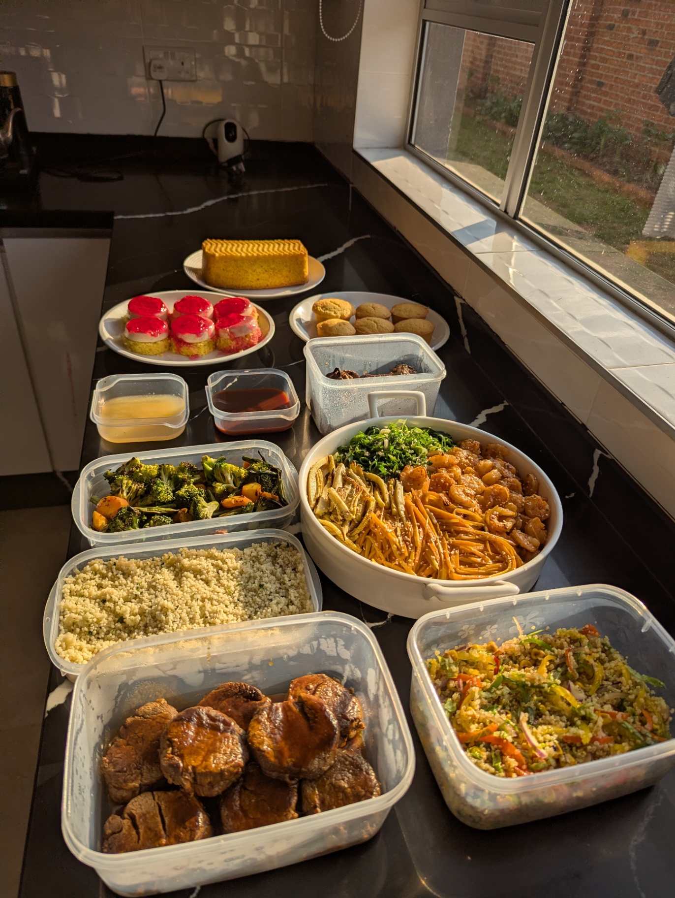 Buffet spread with prawns, beef medallions, cakes and salads