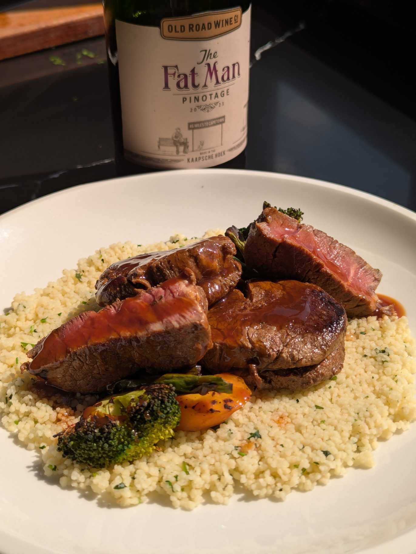 Seared beef medallions on herbed couscous with Pinotage